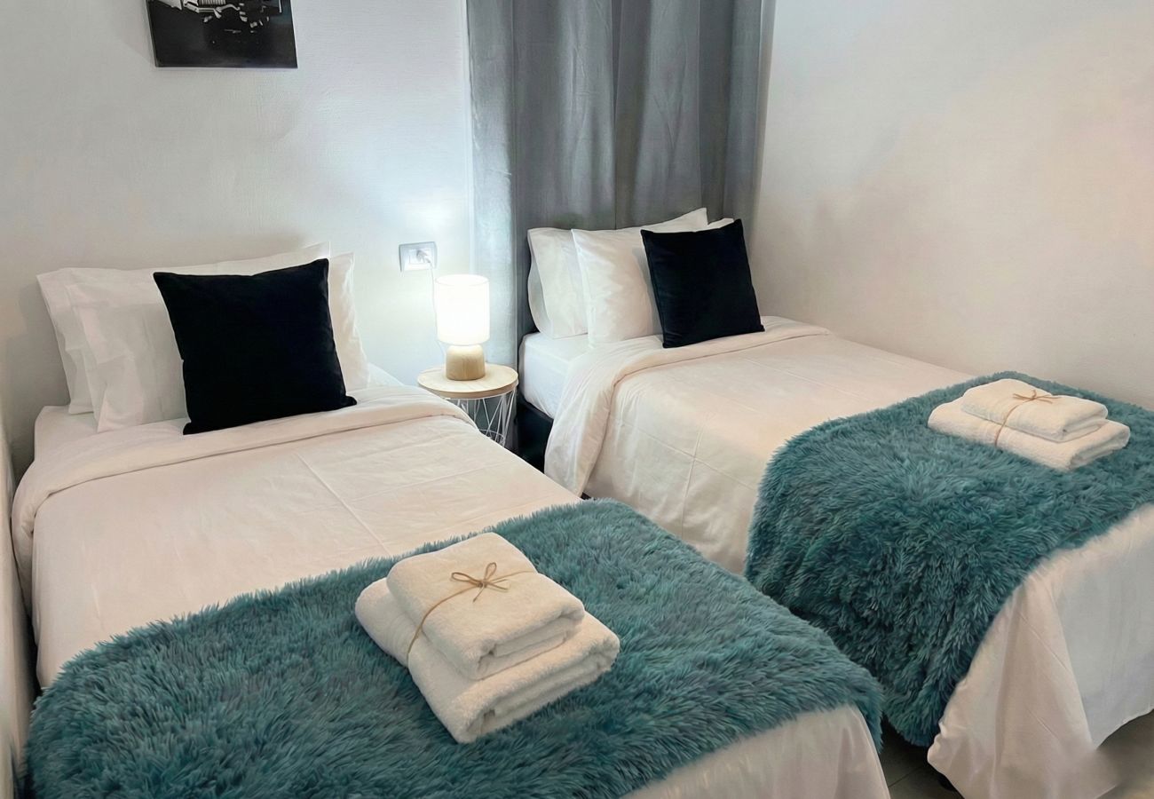 Two single beds with blue blankets