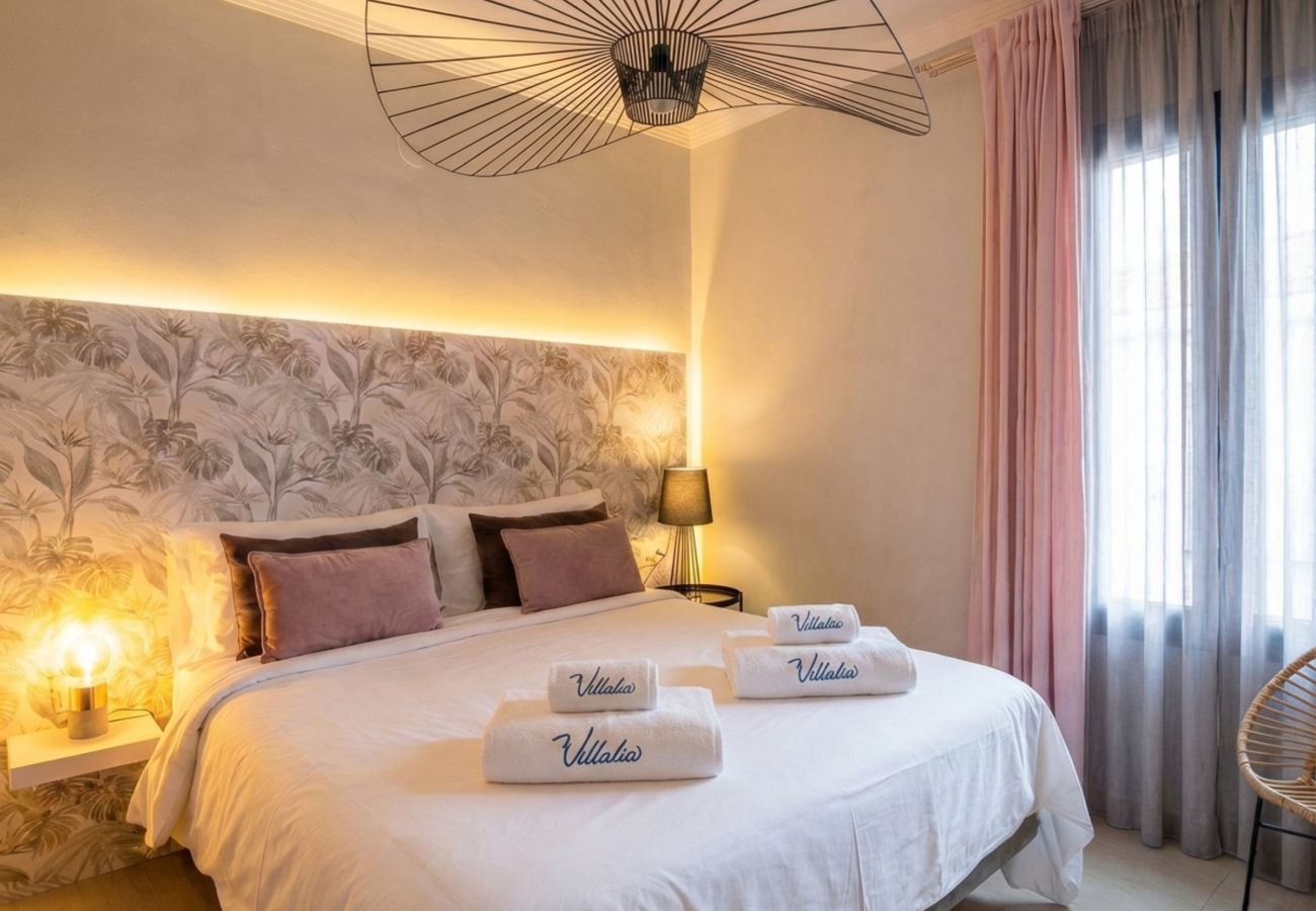 Double bed with illuminated headboard and warm decor