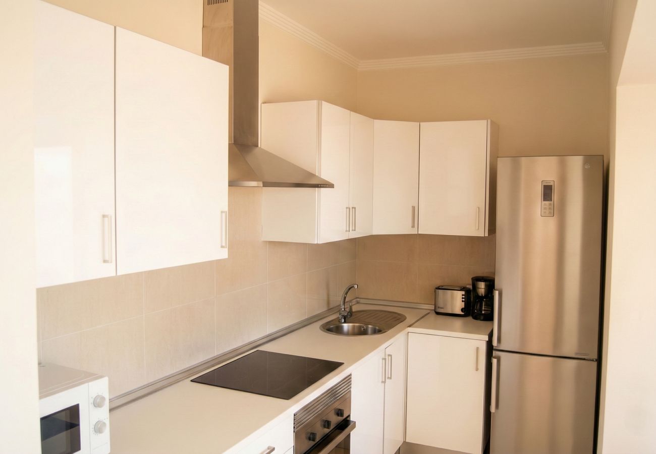 White kitchen with fridge and cabinets