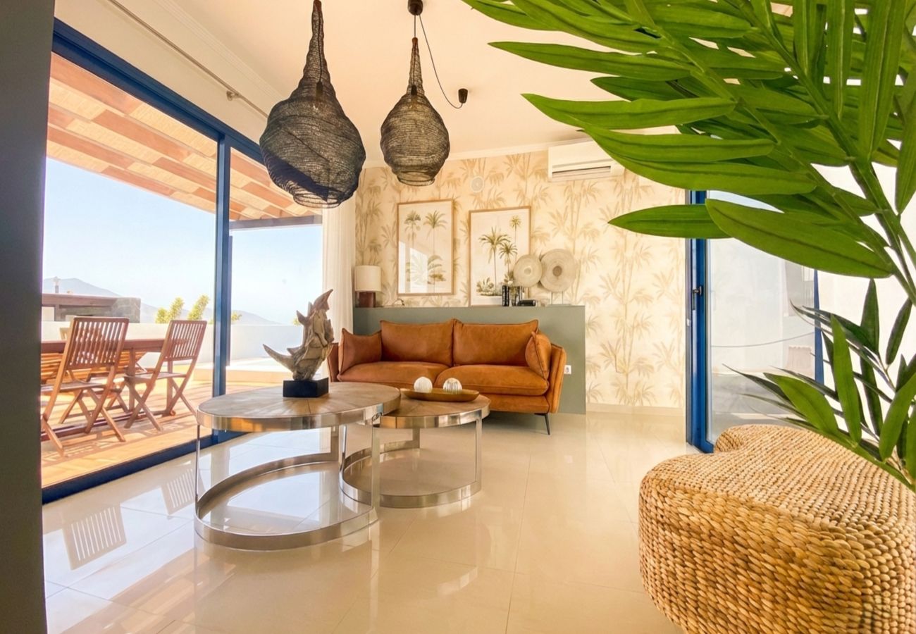 Modern living room with brown sofa and wicker lamps