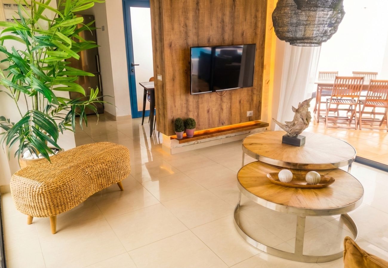 TV unit and plants in bright living room