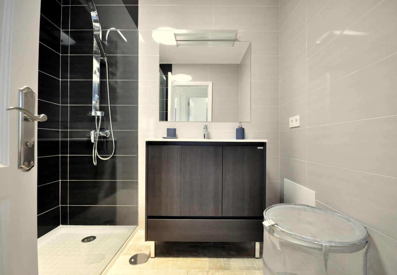 Shower interior with dark tiles