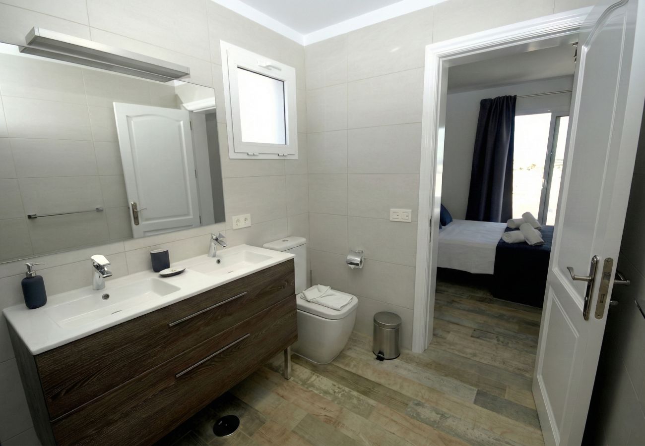 White sink on wooden vanity