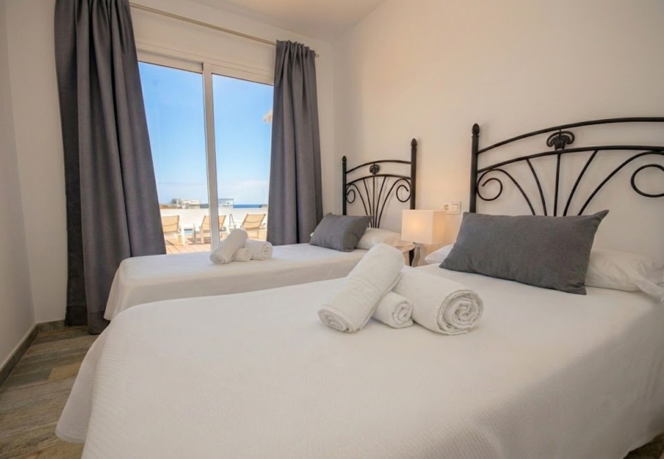 Two single beds with wrought iron headboard