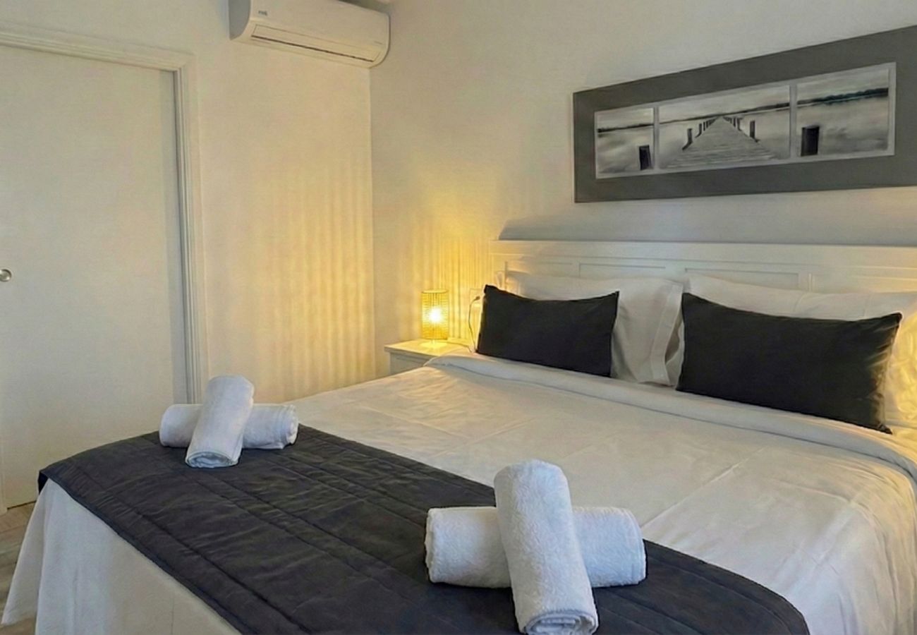 Side view of double bed and bathroom door