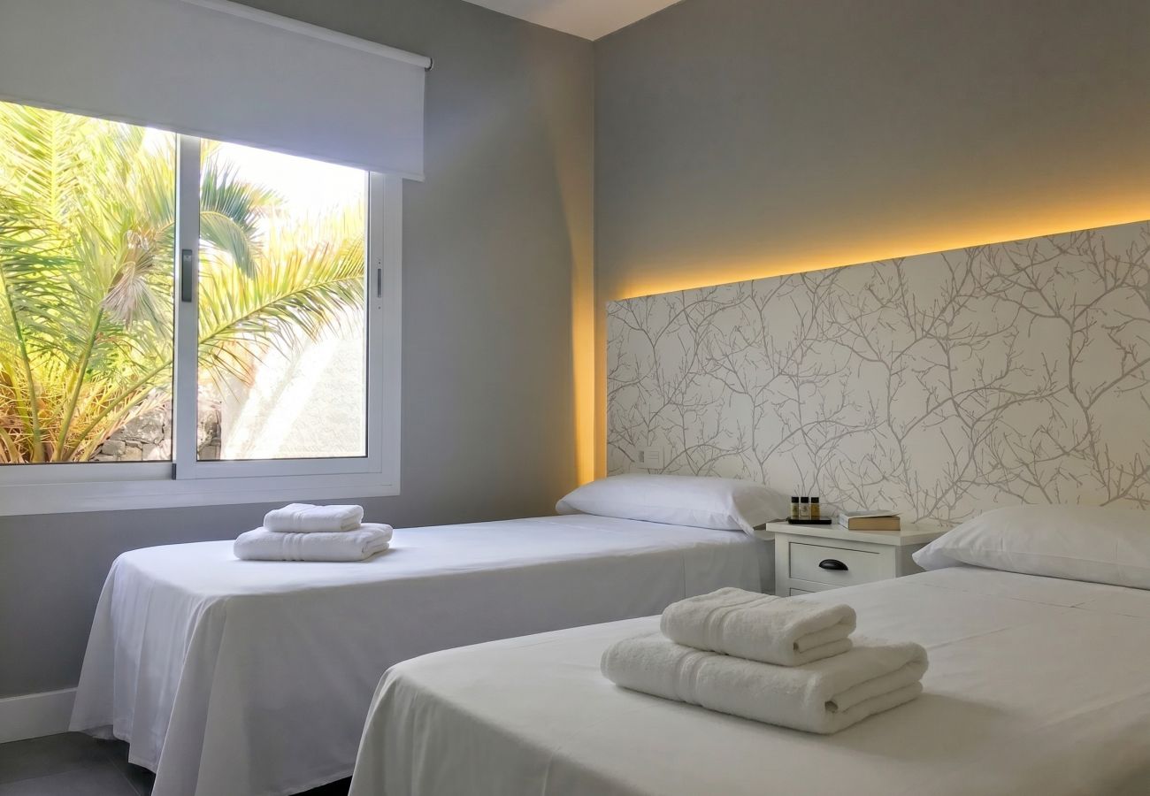 Two single beds with illuminated headboard