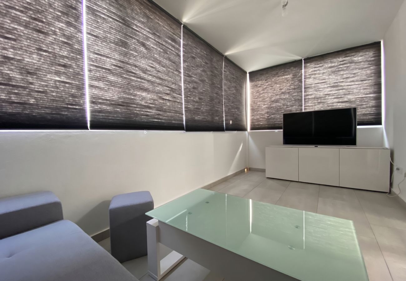 Modern living room with TV and views at Villa Marina Lanzarote