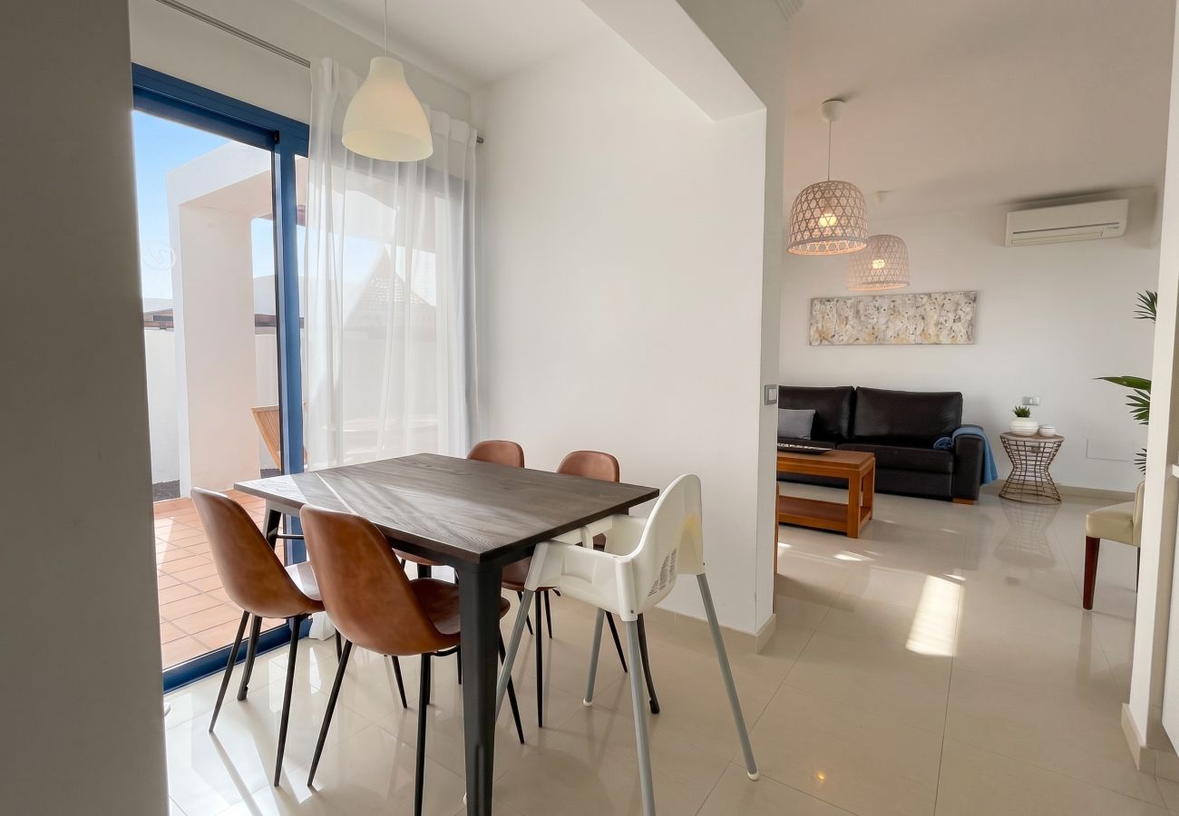 Designer indoor dining table in an open-plan living room.