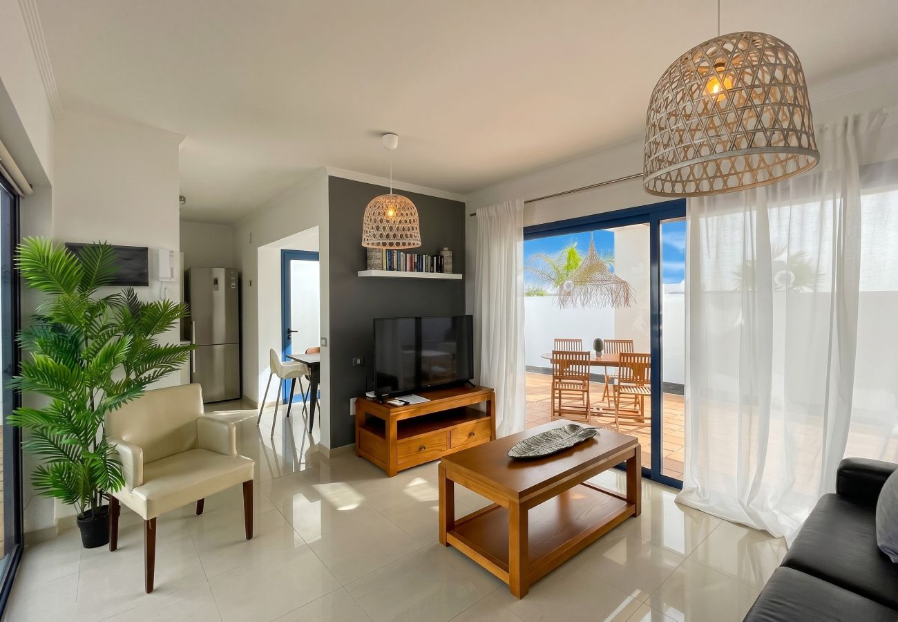 Relaxing living area with comfortable sofa and Smart TV.