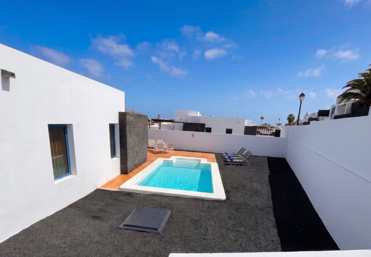Elevated view of the villa, sun terrace, and private pool.